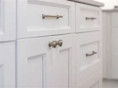 white cabinets with handles and knobs in a kitchen