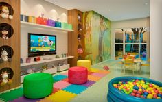 a child's playroom with toys and games on the walls, colorful floor tiles