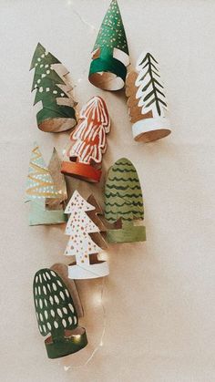 paper christmas trees are hanging on the wall