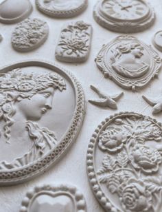 some white molds that are sitting on a table with different shapes and designs around them