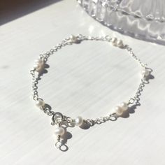 Delicate White Pearl Bracelet with Sterling Silver or 14K Gold Filled 💗✨ Dainty & Elegant. Simply beautiful bridal bracelet. A perfect gift & affordable treat for yourself. • Pearl size: 4 mm• Handmade with genuine white Freshwater Pearls. All metal parts are high-quality 925 Sterling Silver. It also can be made with 14K Gold-filled or Rose Gold-filled • Sterling Silver and 14K gold-filled are known for lasting quality. White proper care, this piece will last for decades and is consider Delicate White Anklet As A Gift, White Sterling Silver Anklets As Gift, White Gold Single Strand Bracelet Gift, White Gold Single Strand Bracelet As Gift, Dainty White Wedding Anklets, Dainty Wedding Bracelet With Lobster Clasp, Gold Pearl Bracelet, White Pearl Bracelet, Rose Gold Pearl