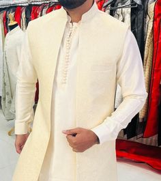 This is a premium kurta pajama by Golden Attire crafted from high quality fabric and imported materials. Our products are handcrafted by experienced tailors who make sure the that the stitching is precise, lining is proper and the overall product is sturdy enough to not go out of shape for more than a few years. Also all our products have extra margins in their length, sleeves, sides so it's easily alterable if your size changes after some time. To see more available colours and designs in this White Nehru Jacket For Groom At Festivals, Off White Nehru Jacket With Dabka For Festive Occasions, Festive Long Nehru Jacket, Off White Dabka Kurta For Festivals, Stand Collar Kurta For Eid Weddings, Long Groom Kurta With Dabka, White Long Nehru Jacket With Dabka, Beige Long Kurta For Eid, Off White Nehru Jacket With Dabka For Diwali