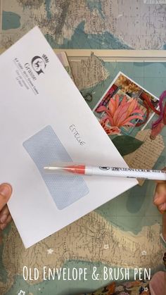 a person holding an envelope with a pen in it