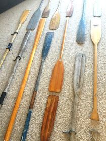 many different types of paddles and spoons laid out on the floor next to each other