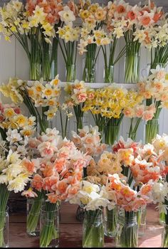 many vases filled with flowers on a table