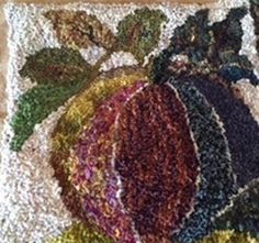 a close up of a rug on the floor with different colors and sizes of fruit