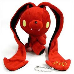 a red stuffed animal sitting next to a chain