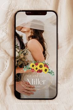 an iphone case with a wedding photo and sunflowers on the front, sitting on a white blanket