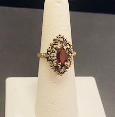 Beautiful 10k Gold ladies antique Gold garnet gemstone ring Size 6.5(Re-Sizing is available if needed) Please see my shop with hundreds of other incredible pieces of unique jewelry! We are a 100 year old, 5th generation, family business called Colonial Coin & Jewelers in Cleveland Ohio.  Satisfaction guaranteed or return for full refund. Antique Gold Ruby Ring Stamped 14k, Ornate 14k Gold Collectible Ring, Victorian Ruby Ring In Yellow Gold With Intricate Design, Victorian Yellow Gold Ruby Ring With Intricate Design, Antique Gold Ruby Ring Hallmarked, Antique Gold Ruby Ring With Intricate Design, Vintage 14k Stamped Sapphire Ring Collectible, Ornate Yellow Gold Ruby Ring With Intricate Design, Vintage Oval Garnet Birthstone Ring