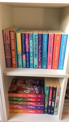 a book shelf filled with lots of books on top of white shelves next to each other