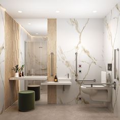 a bathroom with marble walls and flooring next to a toilet, sink, and shower