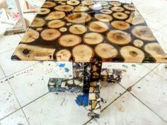 a table made out of wood slices on the floor in a room with tile floors