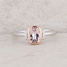 This ladies 14k white and rose gold ring has a cushion morganite that weighs 0.63ct. It is set in a rose gold bezel. The shank is white gold and the finger size is 6.5. There are ten round brilliant diamonds that weigh 0.06ctw and the ring weighs 2.7 grams. Condition: New *All items are thoroughly inspected for quality assurance purposes Rose Gold Cushion Cut Morganite Ring, Rose Gold Morganite, Brilliant Diamond, A Rose, Morganite, Quality Assurance, Rings Statement, Round Brilliant, Rose Gold Ring