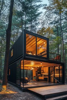 a small cabin in the woods with lots of windows