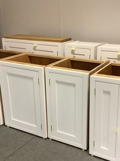 several white cabinets are lined up against the wall