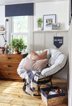 a living room filled with furniture and lots of plants on top of a wooden floor