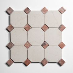 a white and brown tiled wall with small squares