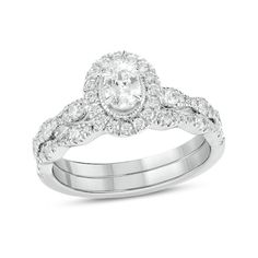 a wedding ring set with an oval cut diamond and pave diamonds on the band