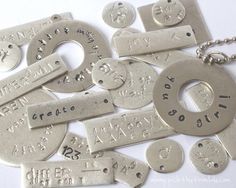 many different types of metal tags on a white surface with the words written in them