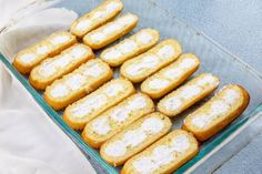 a glass dish filled with cookies on top of a blue tablecloth and white cloth