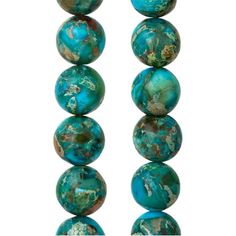 several turquoise colored beads are lined up on a white surface