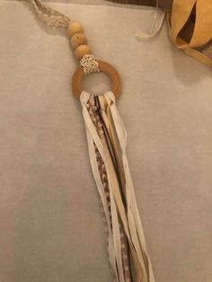 a wooden beaded keychain hanging from a string on top of a piece of paper