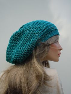 This posting is for the awesome slouchy tam colors you see pictured. The hat for this posting was made with a band of 18 inches around with some stretch room if needed. The bag itself is 28 inches wide at its widest point. The hat is 12 inches from band to tip of the hat.  This hat is an interesting teal. We take our photos outside in natural lighting. If the sky is overcast the color is a blue teal. If the sky is sunny, it brings out the more dark green teal shade. It is a very nice change betw Handmade Slouchy Cap, Handmade Slouchy Cap Hat, Handmade Casual Beret One Size, Handmade Casual One-size Beret, Casual Handmade Beret, One Size, Casual Handmade Beret, One Size Fits Most, Rasta Hat, Hippie Hat, Green Cap