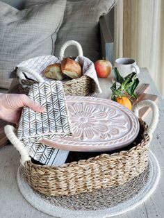 a person holding a tray with food in it on a table next to a couch