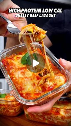 someone is holding a casserole dish with cheese and spinach on it while another person holds a spoon in their hand