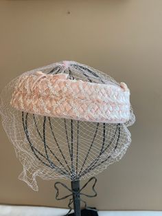 "Pink Wedding Halo Hat with Veil, Women's Birdcage Vintage Fashion Veiled Mini Raffia Hat, MCM Crown Hat, Church Lady Hat Lovely woven raffia outer with pink velvet bow accent. This is a crown or halo hat with a fabric base, woven raffia detail. The netting is in great condition, no tears. It is placed a little longer in the front. Very well made and cared for. No label. Inside circumference: 22\". Made in the age of hats! No label. No obvious defects, tears or holes. Thank you for looking. This Pink Wedding Hat With Structured Crown, Adjustable Cloche Straw Hat For Wedding, Pink Fitted Hat With Structured Crown, Adjustable Pink Straw Hat For Wedding, Pink Adjustable Straw Hat For Wedding, Pink Straw Hat For Wedding, Fitted Wedding Hat With Ribbon, Adjustable Costume Hats With Pinched Crown For Church, Curved Brim Hat With Ribbon For Church