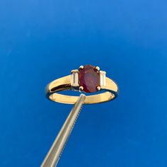 Designer 14K Yellow Gold Oval Ruby Diamond Accent July Birthday Anniversary Ring Ring size: 4.75 Top of ring measures: 1/4" x 3/8" Height: 1/4" Band width: 2.10 mm or approximately 1/8" Ruby oval measures approximately 6.4 mm x 4.75 mm Diamond straight baguettes measure approximately 2.6 mm x 1.2 mm each Ring weight: 2.1 tgw Marked: MAKERS MARK * 14K * 585 Ring can be resized for an additional fee. Condition: As pictured. G2750 6% Restocking Fee Mod Engagement Ring, Ruby Ring Vintage, Ruby Wedding Rings, All That Glitters Is Gold, July Birthday, Ruby Engagement Ring, Future Goals, Ruby Diamond, Garnet Rings