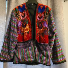 Vintage Guatemalan Art To Wear Boho Embroidered Velvet Jacket L. Front Panels In Red Velvet With Embroidered Flowers And Birds. Purple Panel Above Pockets With Metallic Threading. 2 Big Front Pockets, Back Is Striped. Very Colorful. Excellent Condition. Fits Up To A Large, Can Be Work Oversize. 42" Bust, 29" Long, 25" Sleeves Multicolor Long Sleeve Outerwear With Floral Embroidery, Multicolor Floral Embroidered Long Sleeve Outerwear, Bohemian Long Sleeve Outerwear With Intricate Embroidery, Folk Style Multicolor Outerwear With Floral Embroidery, Multicolor Folk Outerwear With Floral Embroidery, Fall Multicolor Outerwear With Floral Embroidery, Traditional Multicolor Outerwear For Fall, Multicolor Floral Embroidery Outerwear For Fall, Red Folk Embroidered Outerwear