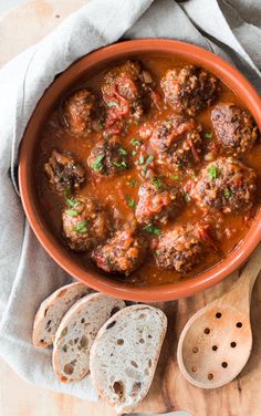 meatballs and bread in a bowl on a table