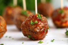 some meatballs with toothpicks in them on a table