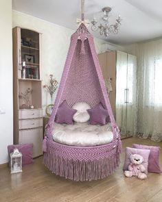 a bedroom with a bed, chair and teddy bear