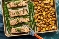 salmon, green beans and potatoes on a baking sheet