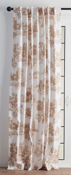 the curtains are hanging in front of a window with brown and white toilers on them