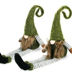 two green knitted gnomes with long hair and tails