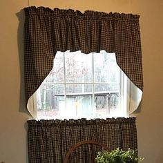 a kitchen window with black and white checkered curtains