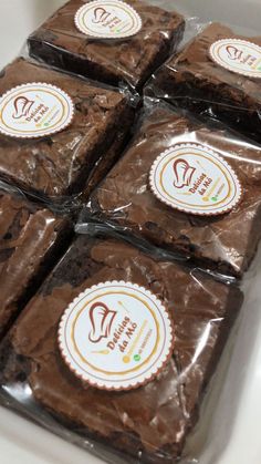 chocolate brownies wrapped in plastic sitting on top of a counter