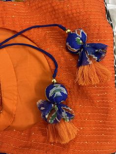 an orange purse with blue and white flowers on it