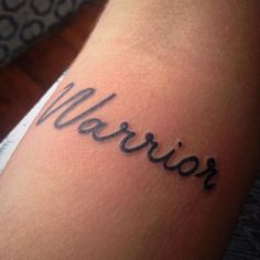 a woman's arm with the word warrior written in cursive writing on it