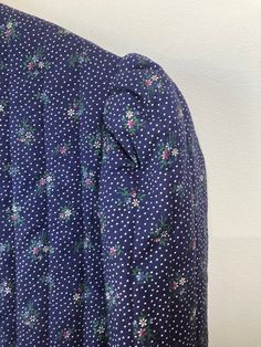 Vintage Gunne Sax Navy Floral Cropped Jacket in excellent condition. Such a darling creation. A dainty floral patterned quilt base with a Vintage Gunne Sax Navy velvet lapel with lace detail. Awesome purple color lined inside. Best fits S. 100% cotton print and velveteen, polyester filling, nylon trim. Made in the USA. Dry clean only. Approx. Measurments: Underarm to unerdarm: 19" Length: 19" Long Sleeve Cotton Outerwear With Lace Trim, Cotton Long Sleeve Outerwear With Lace Trim, Patterned Quilt, Navy Velvet, Gunne Sax, Color Lines, Cropped Jacket, Navy Floral, Purple Color