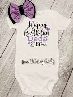 Birthday themed baby bodysuit with a mix of style fonts, featuring fun birthday party elements with the words "Happy Birthday Dada/ Daddy". This is a custom design with your baby's name at the bottom, "Love, (baby's name)". This would be a great outfit for birthday photos with dad! This would also make a great keepsake. This design is pressed on a soft, comfy, organic Gerber Onesies® bodysuit. Playful White Onesie For Birthday, White Playful Onesie For Birthday, Unisex Cute Onesie For Birthday, Playful Letter Print Onesie For Birthday, Birthday Cotton Onesie With Letter Print, Customizable White Onesie For Birthday, Custom Print Cotton Onesie For Birthday, Cotton Birthday Onesie With Letter Print, Playful Letter Print Onesie For First Birthday