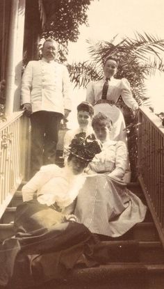 an old black and white photo of people on stairs