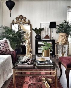 a living room filled with lots of furniture and plants on top of a coffee table