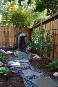 a small garden with rocks and water features