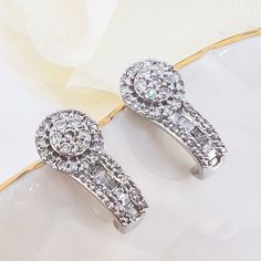 These beautiful earrings are made of solid 10k white gold and feature a diamond rosette style. There are 72 pcs, genuine, single and full cut, round diamonds set in a rosette arrangement with an accent bar that is adorned by an additional 16pcs, tapered baguette diamonds (F, SI3, mm and weigh 0.50ctw). These earrings measure 4.5x7mm and weigh 2.15grams.  Brand new earrings.   These earrings will ship in a jewelry gift box. Thank you for looking and please visit my store panamericangem1 for more Round Diamond Setting, New Earrings, Baguette Diamonds, Diamond Stud Earrings, Diamond Stud, Baguette Diamond, Fine Jewellery Earrings, Jewelry Gift Box, Diamond Earrings Studs