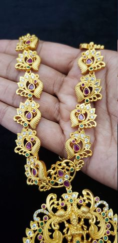 "Stunning Necklace with White, Ruby, Emerald, Pearls and Cubic Zircon. Handmade Indian Temple Jewelry, best to wear it for traditional ceremonies or Indian wedding. This bridal jewelry has ethnic finish. It has Cubic Zircon stones with ruby and emeralds. It is a Bollywood style one gram jewelry. There are long and short patterns of Indian jewelry in Kundan, Pearls, CZ, American Diamond , ruby, emerald, Polki, kemp to suit every occasion of South Indian and North Indian weddings. Handmade Indian Intricate Design Necklace For Marriage And Diwali, Intricate Design Necklace For Marriage During Diwali, Intricate Diwali Necklace For Marriage, Temple Jewelry Tilla Necklace For Marriage, Gold Cutdana Necklaces For Marriage, Wedding Kundan Bridal Necklace With Peacock Design, Wedding Bridal Necklace With Kundan And Peacock Design, White Wedding Jewelry With Peacock Design, Traditional White Necklace With Peacock Design