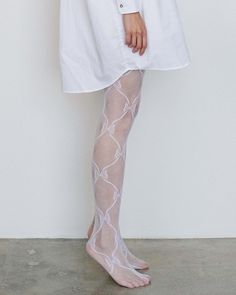 ONLY 1 LEFT IN STOCK Beautifully detailed lace ribbon thigh hi socks from Sheerly Touch-Ya. A family owned and operated, Taiwanese-American hosiery brand, the line was founded in 1992 and currently run by artist and fabricator, Serena Chang. The company prides itself on making quality, affordable hosiery and up-cyling dead stock inventory. In homage to the founder's American dream, Sheerly Touch-Ya's original packaging design has stayed true to its roots over the decades. One size FINAL SALE Com Spring Thigh-high Legwear With Lace Trim, White Stretch Lace Hosiery, White Lace Hosiery, White Lace Thigh-high Legwear, White Stretch Hosiery With Lace Trim, White Stretch Lace Trim Hosiery, Fitted White Hosiery With Lace Trim, White Lace Legwear For Spring, Spring White Lace Legwear